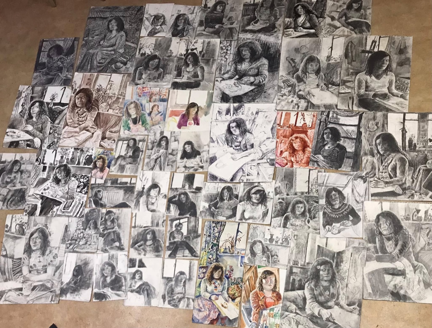 A wall of Sarah Longley's self-portrait studies in the studio